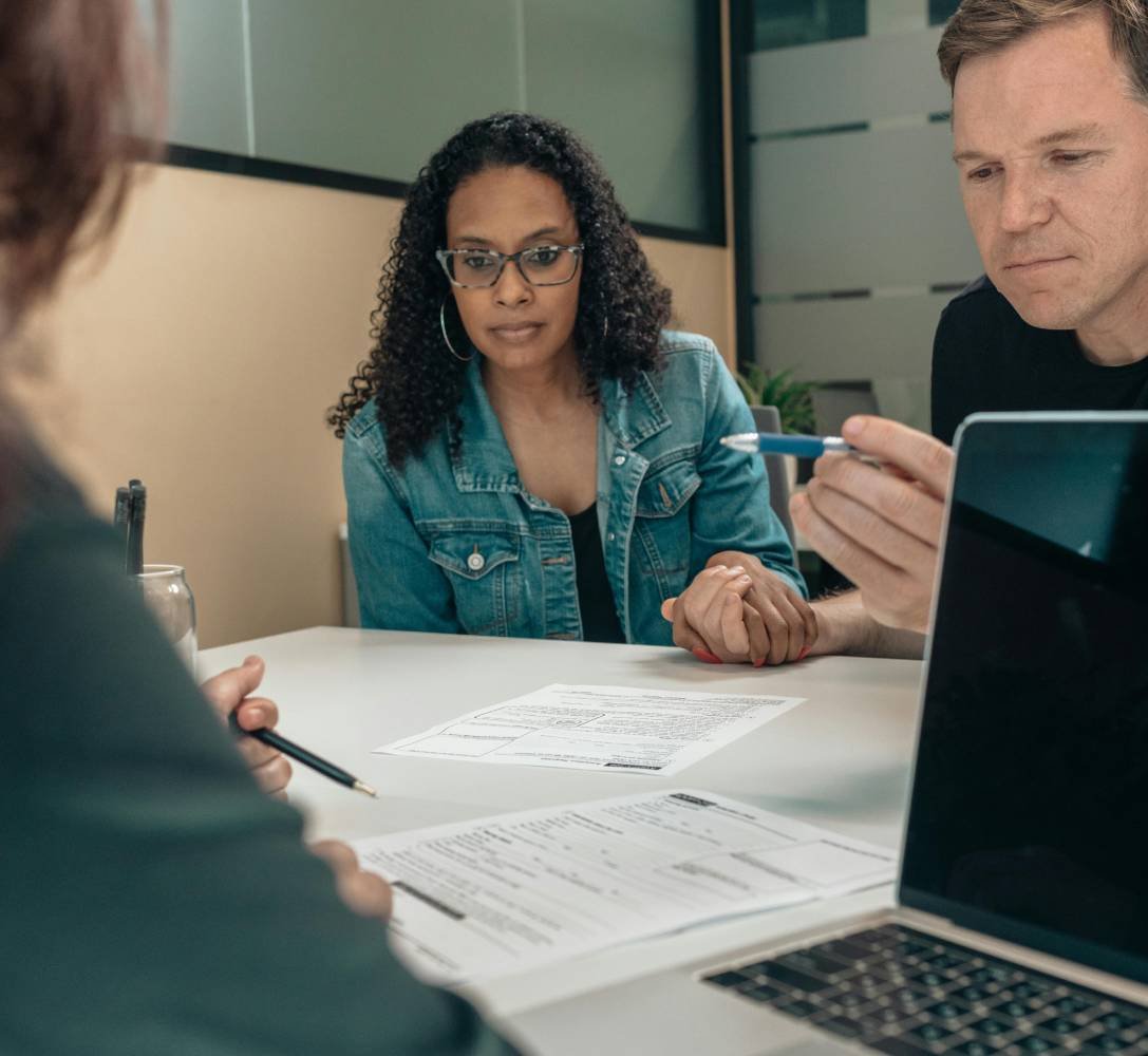 Two people reviewing documents during a professional meeting