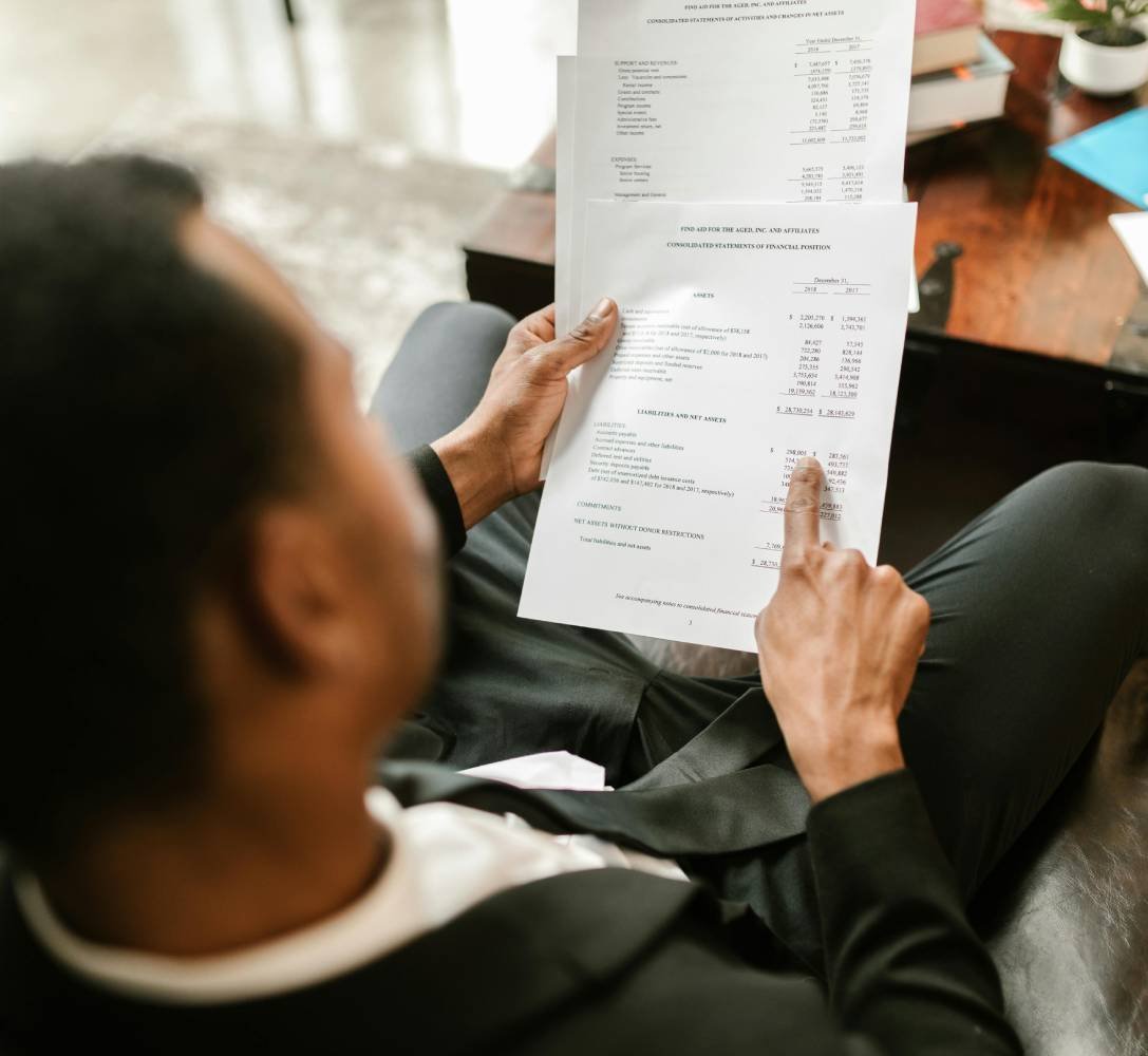 Person reviewing financial documents during a professional meeting