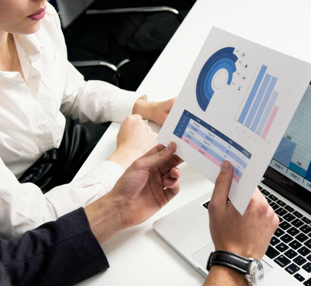 Professionals reviewing financial charts and reports during a meeting