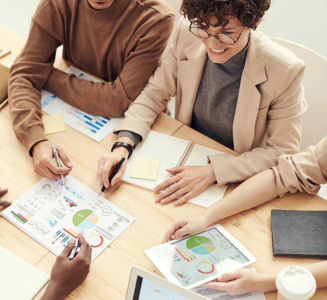 Professionals reviewing financial charts and documents during a meeting